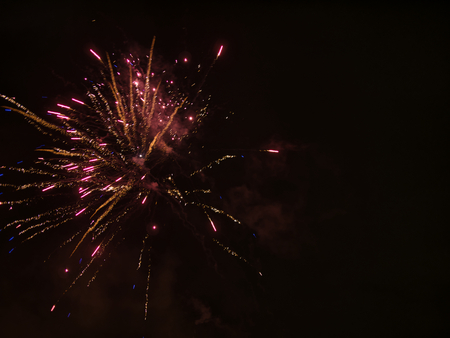 A rocket exploding in the sky with the smoke clouds of the fireworksの写真素材