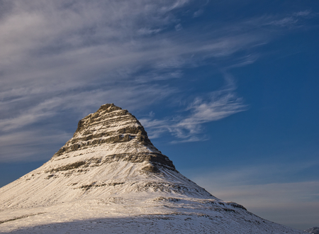 The conical Kirkjufell mountain in Iceland at sunsetの写真素材