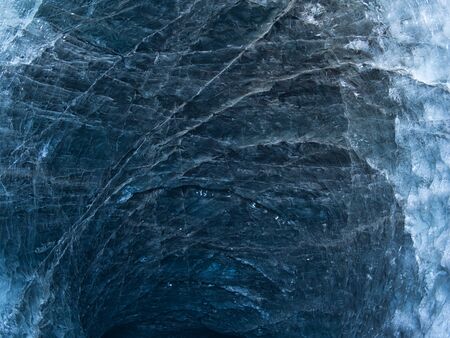 The light-flooded ice inside a glacier in islandの写真素材