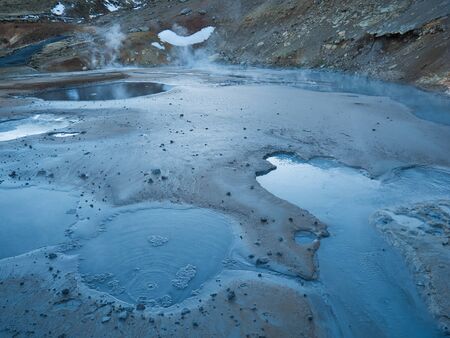 Mud hole in active geothermal area of Iceland at dusk