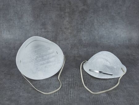 Two face masks with metal temples for the nose and elastic bands