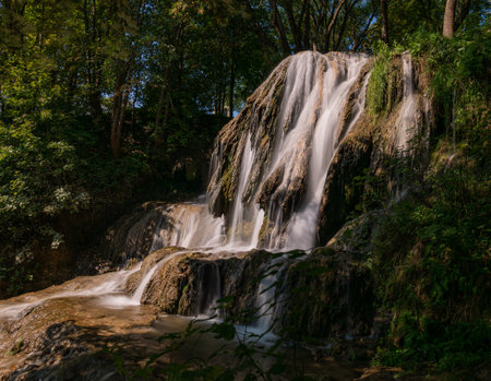 A very beautiful waterfall in a small clearing in the forestの写真素材