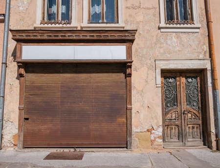 A closed shop window in an old house
