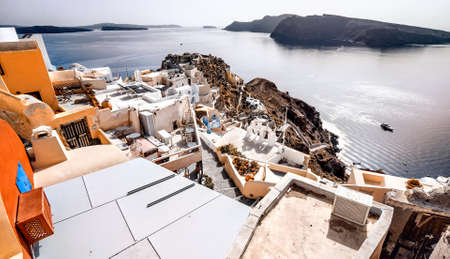 Oia, Santorini - Greece. Famous attraction of white village with cobbled streets, Greek Cyclades Islands, Aegean Sea.の写真素材