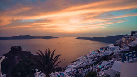 Iconic sunset in the town of Oia on the greek island Santoriniの写真素材