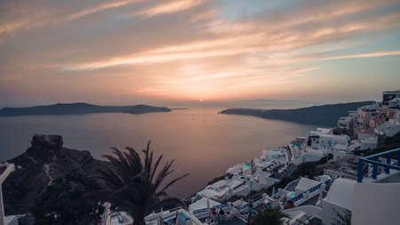 Iconic sunset in the town of Oia on the greek island Santoriniの写真素材
