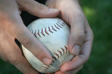 hands holding a baseballの写真素材