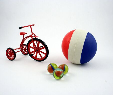 A ball, some marbles and a cast-iron tricycleの写真素材
