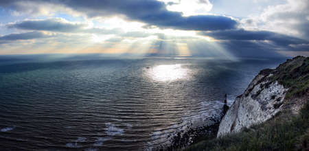 Dramatic clouds and sea. Sunshine from the clouds near Seven sisters in England.の写真素材