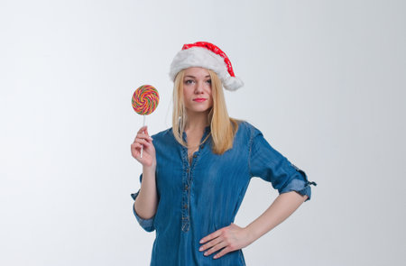santa hat woman holding a lollipop in white screenの写真素材