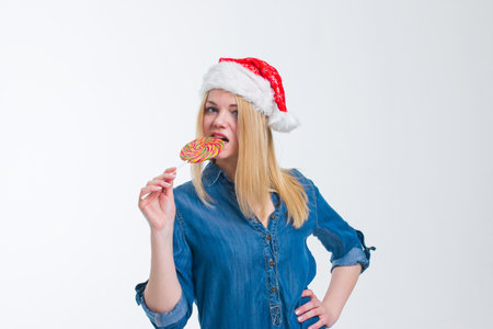 santa hat woman holding a lollipop in white screenの写真素材