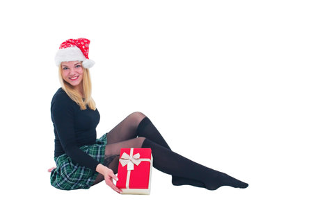 woman sitting with christmas hat and present in isolated backgroundの写真素材