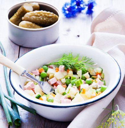 Traditional Russian salad Olivier with cucumbers, green peas and ham. Selective focus.の写真素材