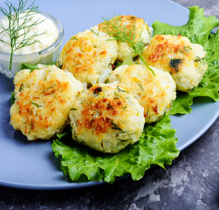 Potato croquettes with dill and sauce on a plate