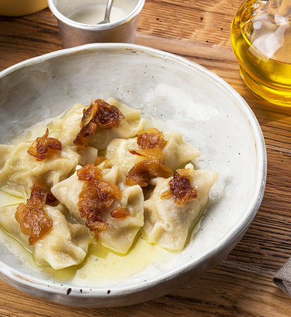 boiled dumplings in a plate on a wooden table.の写真素材