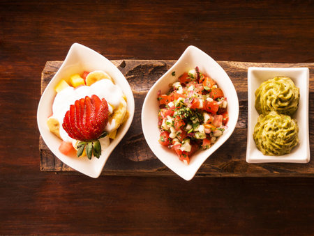 vegetable salad with strawberry and guacamole on wooden backgroundの写真素材