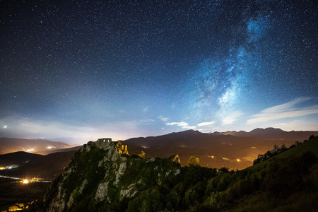 Milky Way over the mountains at night. Starry sky with milky way and stars.の写真素材