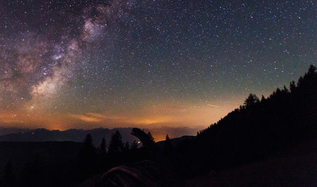 Milky way and stars in the night sky over the mountains.