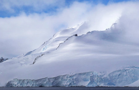 Antarctic landscape with icebergs and snow in the foreground.の写真素材