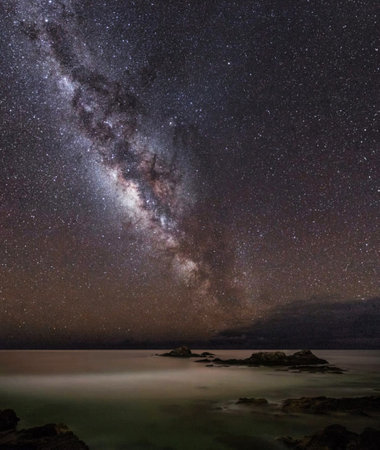 Milky way over the sea at night. Long exposure photograph.の写真素材