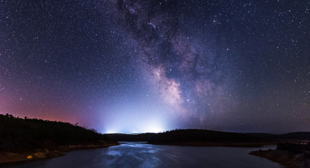 Milky Way over mountain lake at night. Long exposure photograph.