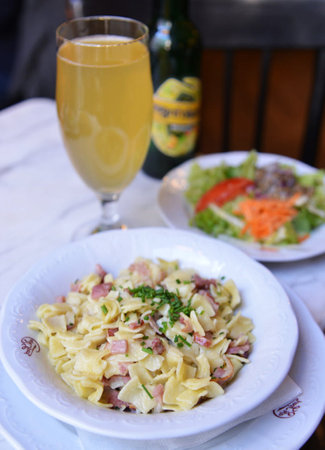 Pasta Carbonara with ham, parmesan cheese and fresh saladの写真素材