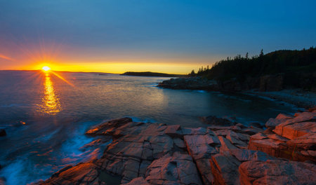 Sunset over the Pacific Ocean in Acadia National Park, Maine.の写真素材