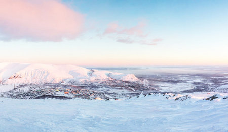 Panoramic view of the snowy mountains at sunset in winter.の写真素材