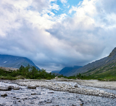 Mountain landscape with river and cloudy sky in the summer. Norwayの写真素材