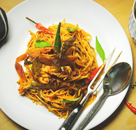 Spaghetti with seafood,Thai food on white plate and spoonの写真素材