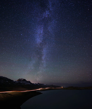 Milky Way over the lake in the mountains. Long exposure photograph.の写真素材