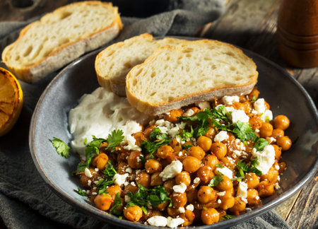 Chickpeas with feta cheese and parsley in a bowlの写真素材