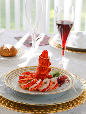 Appetizer of crab sticks on a plate with red wine.の写真素材
