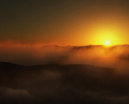 Foggy sunrise over the mountains in the Carpathian Mountainsの写真素材