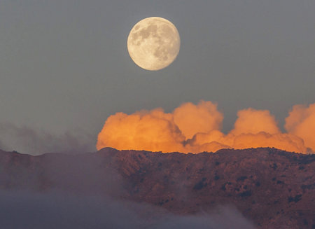 Full moon rising over the clouds on the volcano Teide in Tenerifeの写真素材