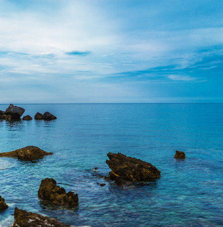 Beautiful seascape with blue sea and rock in the foregroundの写真素材