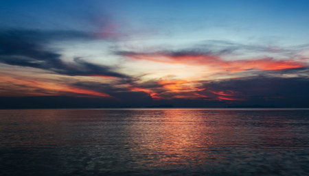 Beautiful sunset on the sea. Dramatic sky with clouds.の写真素材