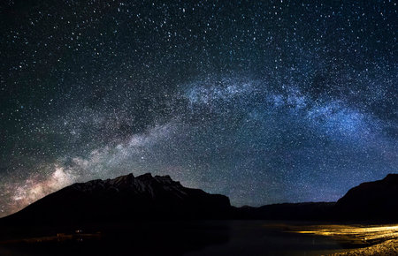 Milky Way over the mountains and lake. Long exposure photograph.の写真素材