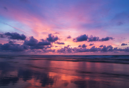 Beautiful sunset on the beach. Colorful sky with clouds.の写真素材
