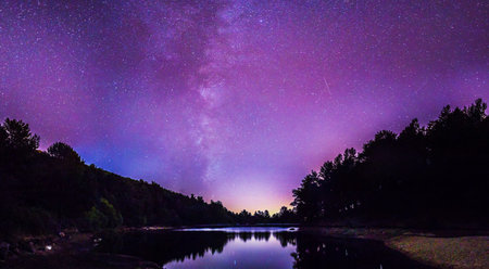 Milky Way over a lake in the forest. Long exposure.の写真素材