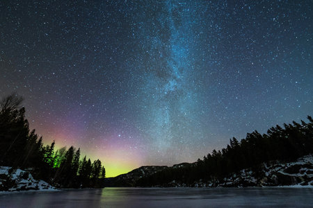 Milky way over the lake in the mountains. Winter landscape.の写真素材