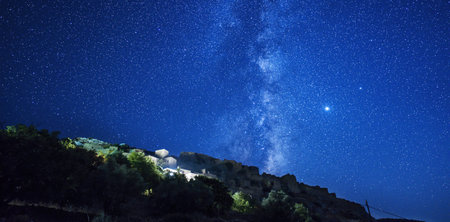 Milky Way over the mountain at night. Long exposure photograph.の写真素材