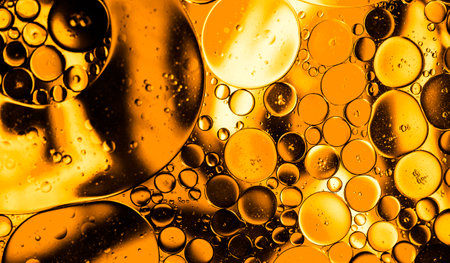 bright oily drops in water with colorful background, close-up shot