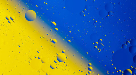 Oil drops in water with blue and yellow background, abstract background.の写真素材