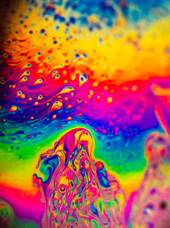 abstract background of oil drops on water surface in rainbow colors.の写真素材