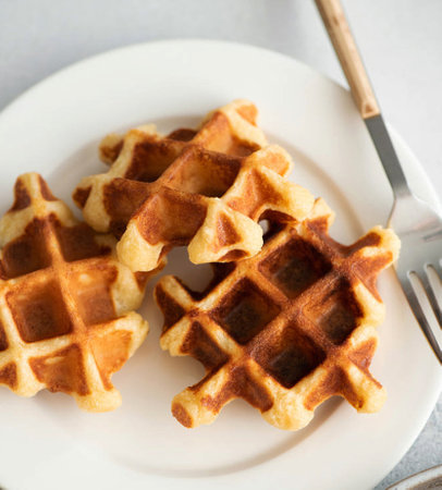 Waffles with kiwi and caramel sauce on a light background.の写真素材
