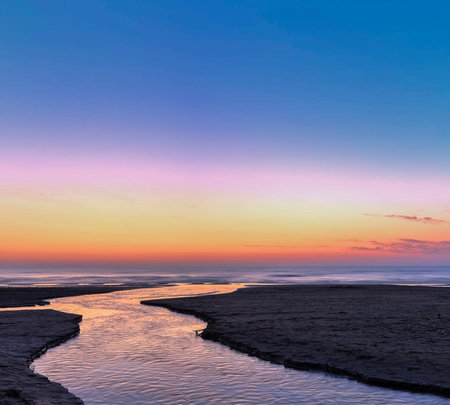 Beautiful sunset over the sea with reflection in water, natural backgroundの写真素材