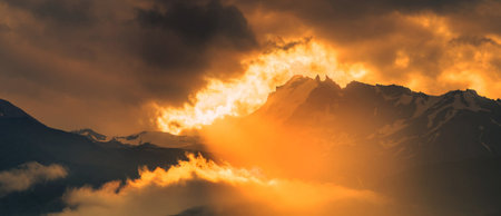 Panorama of the Himalaya mountains at sunset with clouds and sunlightの写真素材