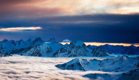 Mountains in clouds at sunset. Caucasus Mountains, Georgia, region Gudauri.