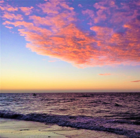 Beautiful sunset on the beach. Colorful sky and sea.